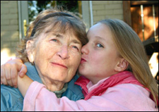 Girl kissing grandmother photo